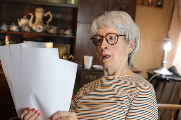 istock Shocked senior woman reading some documents 1453355445