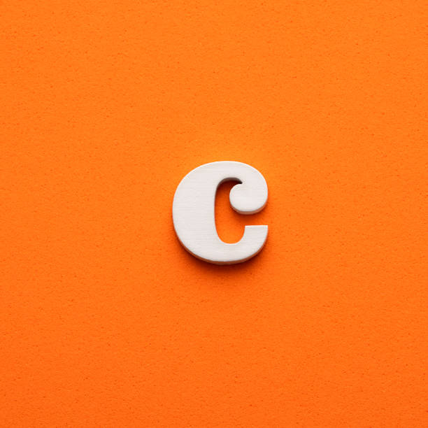 istock c white lowercase letter - Background in orange foamy 1453358629