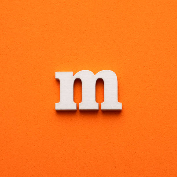 istock m white lowercase letter - Background in orange foamy 1453359259