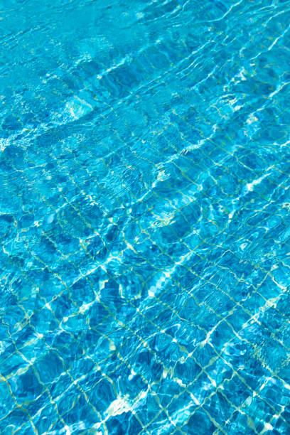 istock Turquoise pool water surface with ripples and waves on sunny day 1453360212