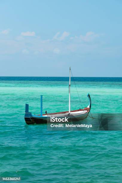 Maldivian Traditional Dhoni Boat Floating In Blue Lagoon Stock Photo - Download Image Now