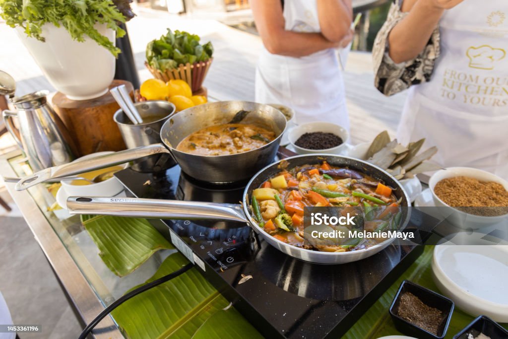 Cooking vegetable Curry in steel pan at kitchen with coconut cream milk and spices Food Stock Photo