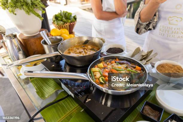 Cooking Vegetable Curry In Steel Pan At Kitchen With Coconut Cream Milk And Spices Stock Photo - Download Image Now