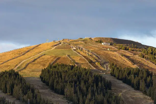 Ski slopes on the Weinebene ski area with missing snow due to warm temperatures caused by climate change