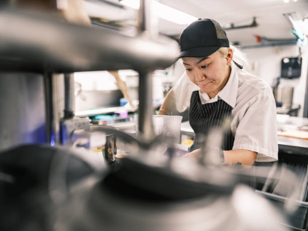 istock Young Korean female chef working in restaurant kitchen 1453363062