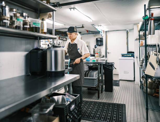 istock Young Korean female chef working in restaurant kitchen 1453363461