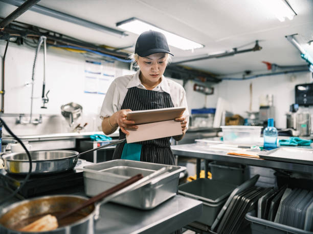 istock Young Korean female chef working in restaurant kitchen 1453363487