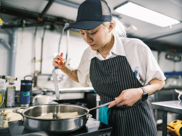 istock Young Korean female chef working in restaurant kitchen 1453363517