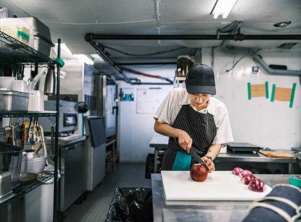 istock Young Korean female chef working in restaurant kitchen 1453364112