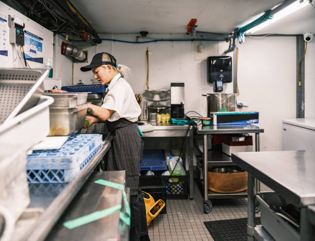 istock Young Korean female chef working in restaurant kitchen 1453364193