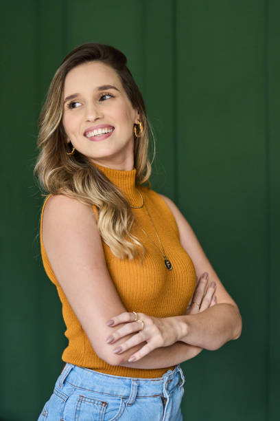 istock Young female architect smiling with her arms crossed in an office 1453365266
