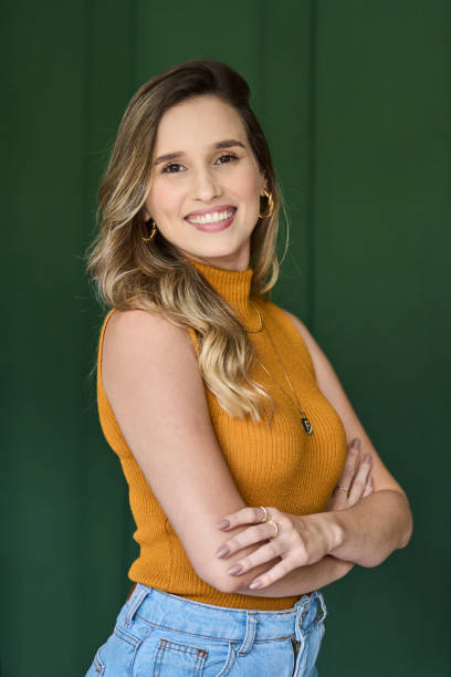 istock Smiling young architect standing with her arms crossed in an office 1453365273