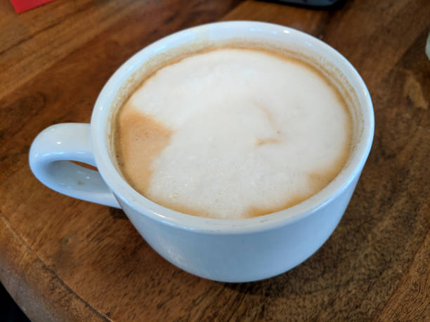 istock White cup of Cappuccino with a Large white dot of foam 1453366912