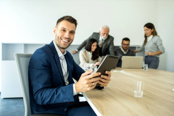 istock Cheerful caucasian young businessman freelancer using digital tablet inside modern office 1453368629
