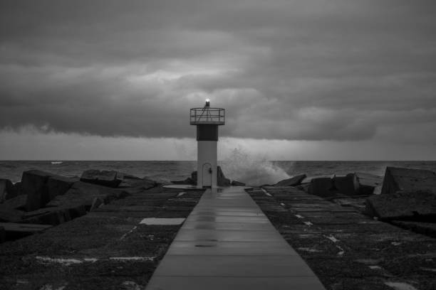 istock Lighthouse in distance at gold coast, black and white 1453370106