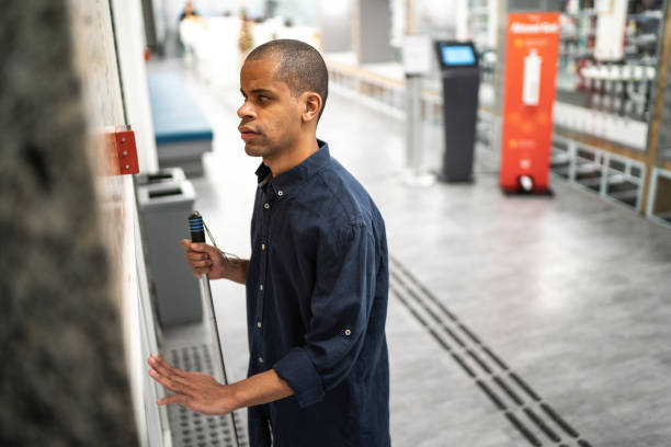 istock Mid adult man visually impaired waiting for the elevator 1453374279