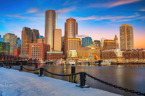 Boston skyline, financial district and harbor at sunrise in winter, Boston, MA, USA