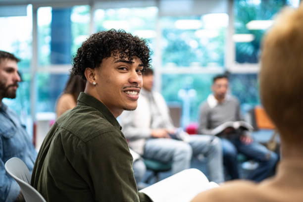 istock Portrait of young university student man in a circle group at university 1453374544