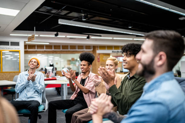istock University students applauding a presentation at the university 1453374618