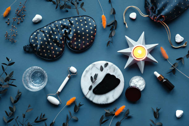 istock Sleeping mask, gua sha stone, massage roller, essence serum, oil bottle. Face care, wellness therapy background. Healthy sleep, massage, natural meditation tools with eucalyptus twigs. 1453374677