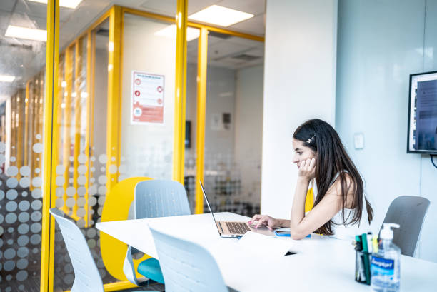 istock Young woman working on laptop at office 1453375290