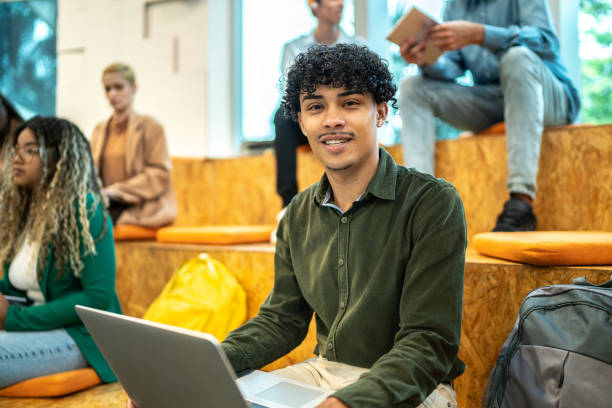 istock Portrait of a young university student man at university auditorium 1453376315
