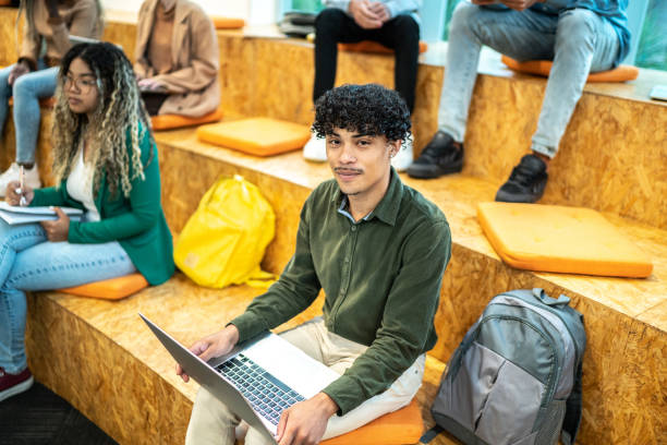 istock Portrait of a young university student man at university auditorium 1453376320