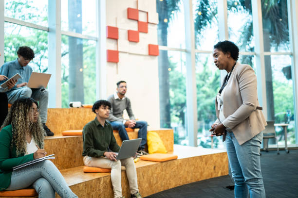 istock Mature teacher giving lecture to students at the university 1453376330