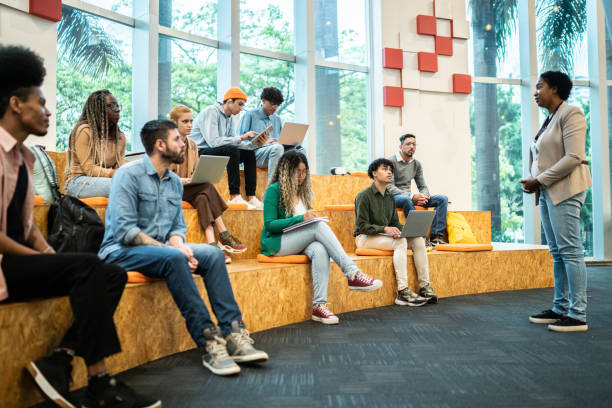 istock Mature teacher giving lecture to students at the university 1453376331