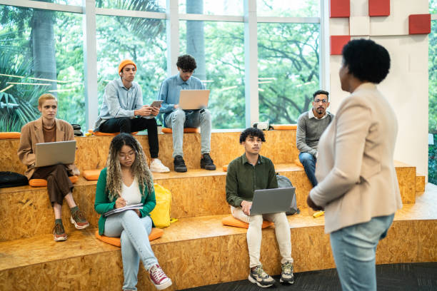 istock Mature teacher giving lecture to students at the university 1453376332