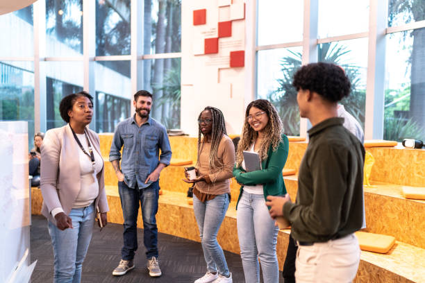istock Mature teacher explaining lesson to university students at university 1453378049