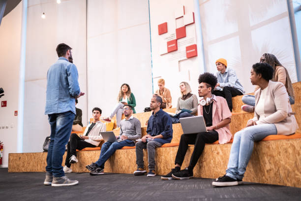 Man giving lecture to students at the university