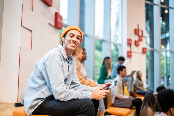 istock Portrait of a young student man at university auditorium 1453378109