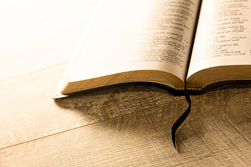 This is a photograph of a Bible on a retro wood background