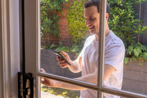 istock Happy man at home using wireless technology, he uses phone 1453382211