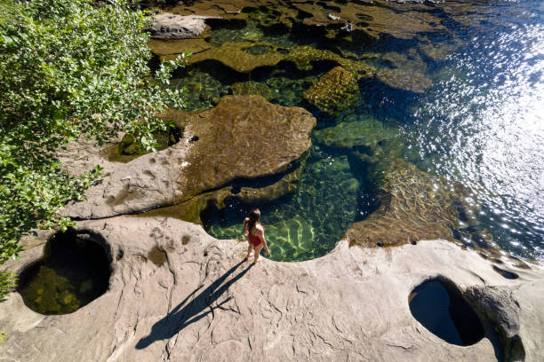 Majestic swimming hole Swimming hole in the Comox Valley of Vancouver Island. Top travel destinations in British Columbia. river swimming women water stock pictures, royalty-free photos & images