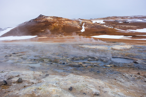 Boiling Mud Pots in the Iceland Volcanically Active Zone and Smoking Cracks in the Ground Around. Location: Geothermal Area Hverir, Myvatn Region, North Part of Iceland, Europe. High quality photo