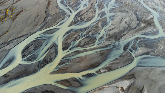 A glacial rivers from above. Aerial photograph of the river streams from Icelandic glaciers. Beautiful art of the Mother nature created in Iceland. Wallpaper background high quality photo. High quality photo