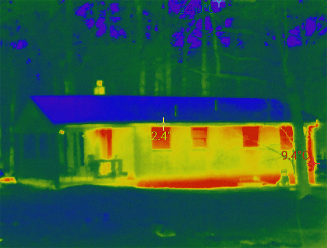 House exterior, taken with infrared camera, showing more heat emission in the brighter parts of the house, helping us to check heat loss and save money.