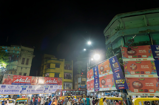 Kolkata, West Bengal, India - 12th October 2021 : Traditional Durga Puja at city of joy, UNESCO Intangible cultural heritage of humanity. Devotees rushing to visit famous Puja pandal at night.