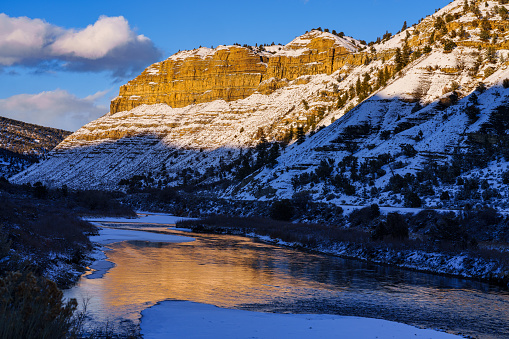 Winter Landscape Sunset Reflections Colorado River - Scenic view with alpenglow on canyon walls reflecting in water.