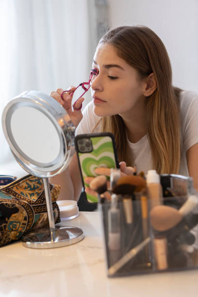 istock Teenage girl using the eyelash curler 1453395481
