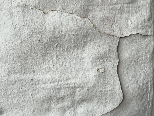 istock The surface of an old wall has been partially repaired. 1453397685
