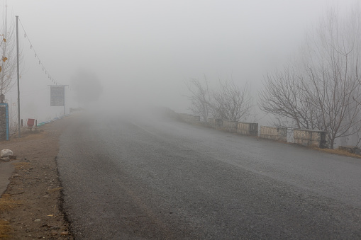Foggy road in the Pakistan countryside with difficult to see the direction