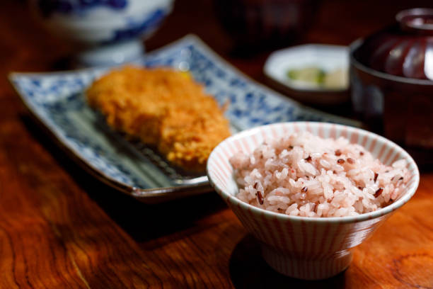 Close up on Japanese fluffy rice served together with deep fried pork cutlet.