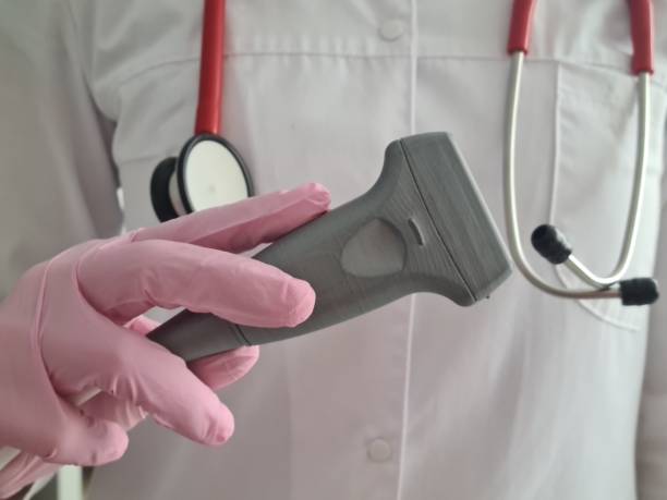 istock Doctor prepares ultrasound machine for diagnosing patient 1453402697