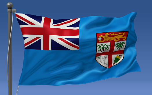 Fiji flag waving on the flagpole on a sky background