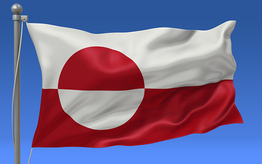 Greenland flag waving on the flagpole on a sky background