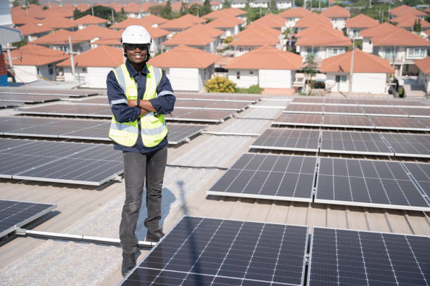 istock Portrait African American engineer man smiling working with solar panel on roof factory 1453405621