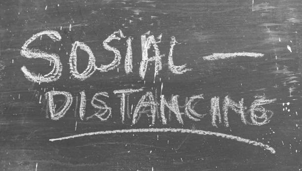 istock Social Distancing text on a black and crayon background 1453406388